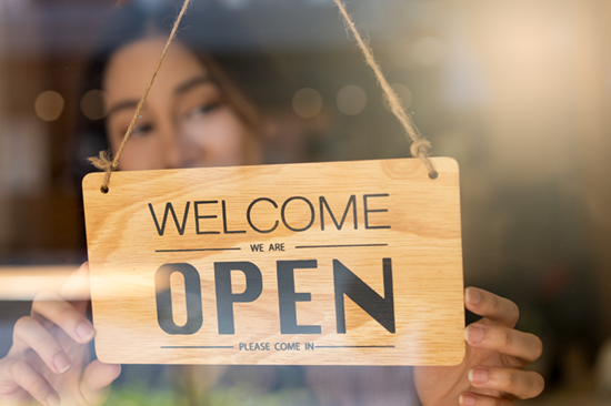 Woman Turning Open Sign